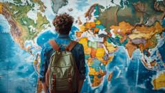 A student standing in front of a world map